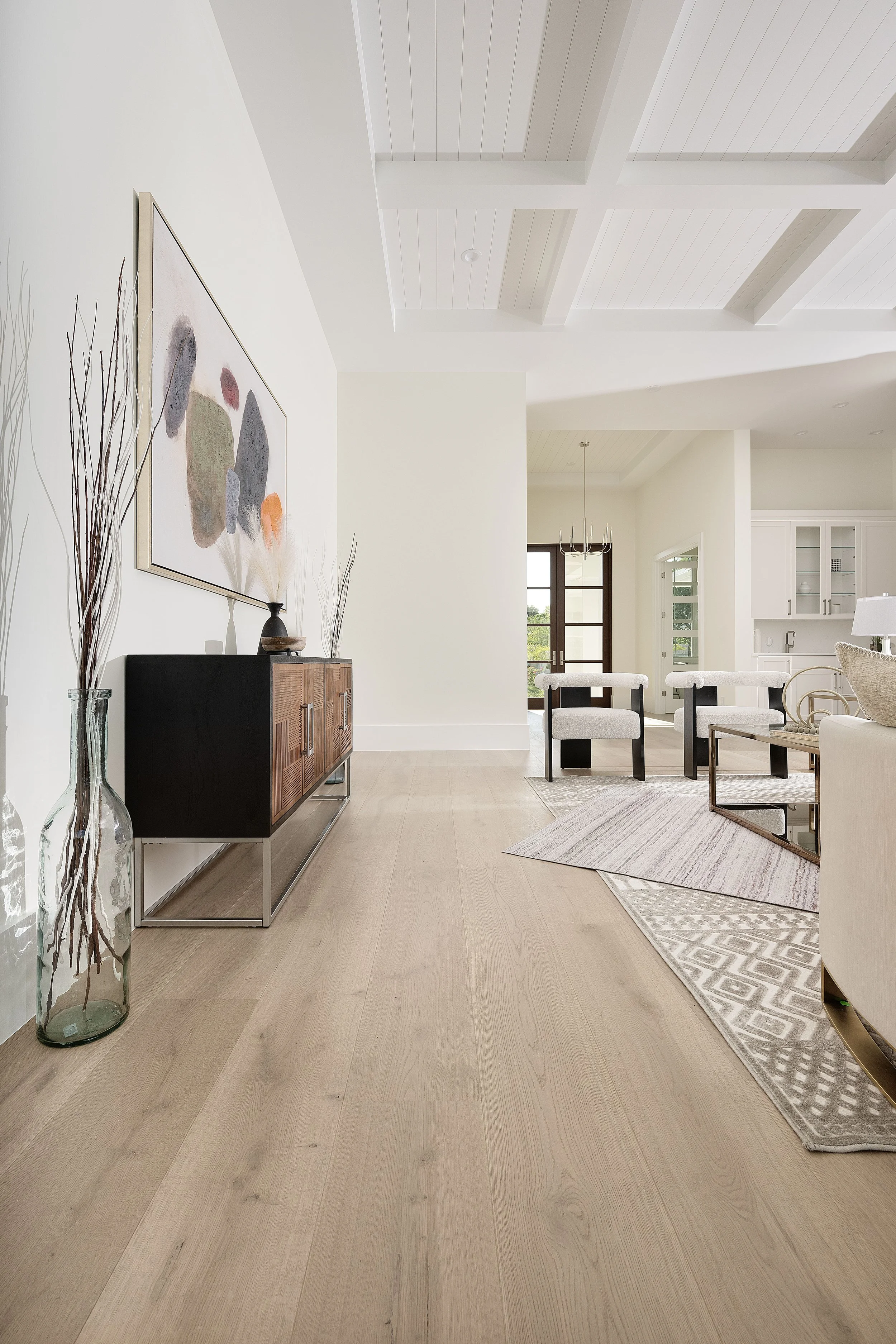 Naples sitting room layered with patterned wool-blend area rugs over wood floor