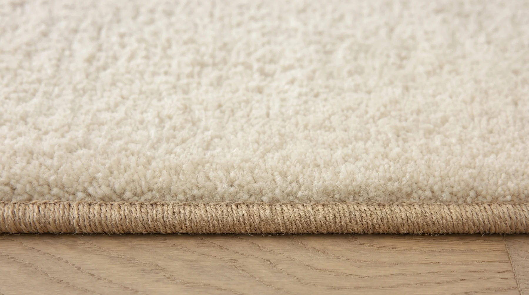 Cut-pile carpet with a serged bound edge