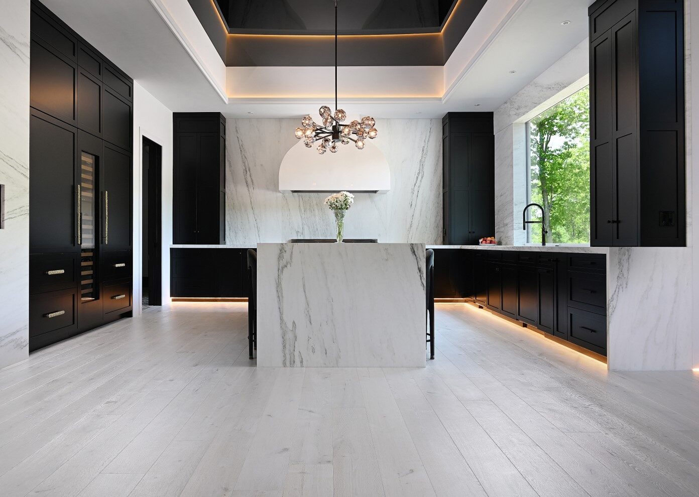 RIVA Spain European white oak wide-plank floor installed in a Naples kitchen with marble and dark cabinetry