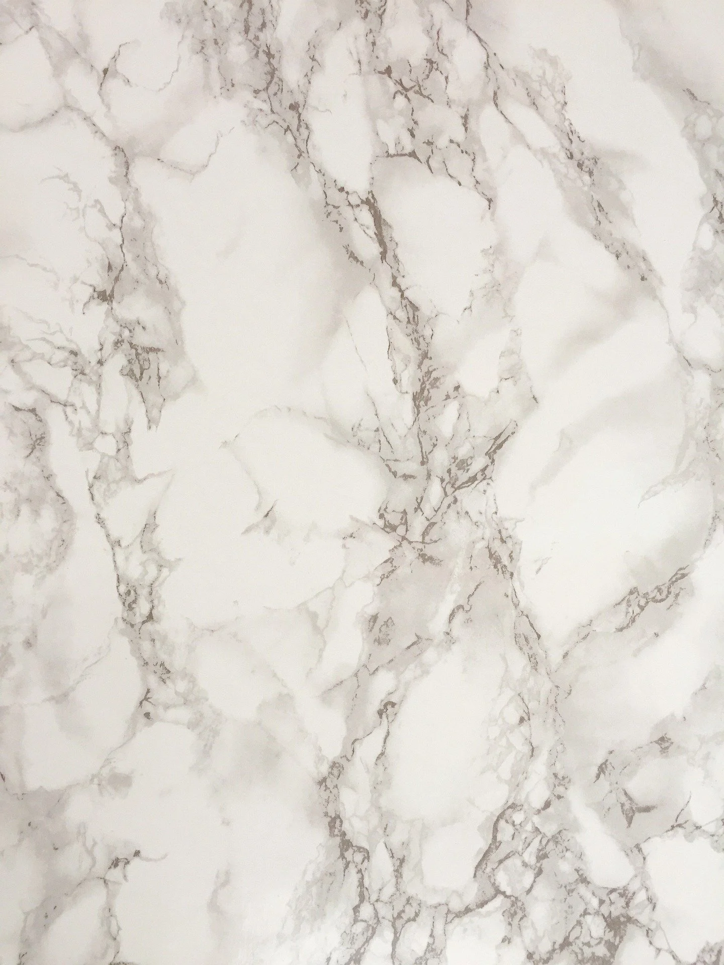 A polished Calacatta marble slab stood up at the Naples slab wall, veining running edge to edge
