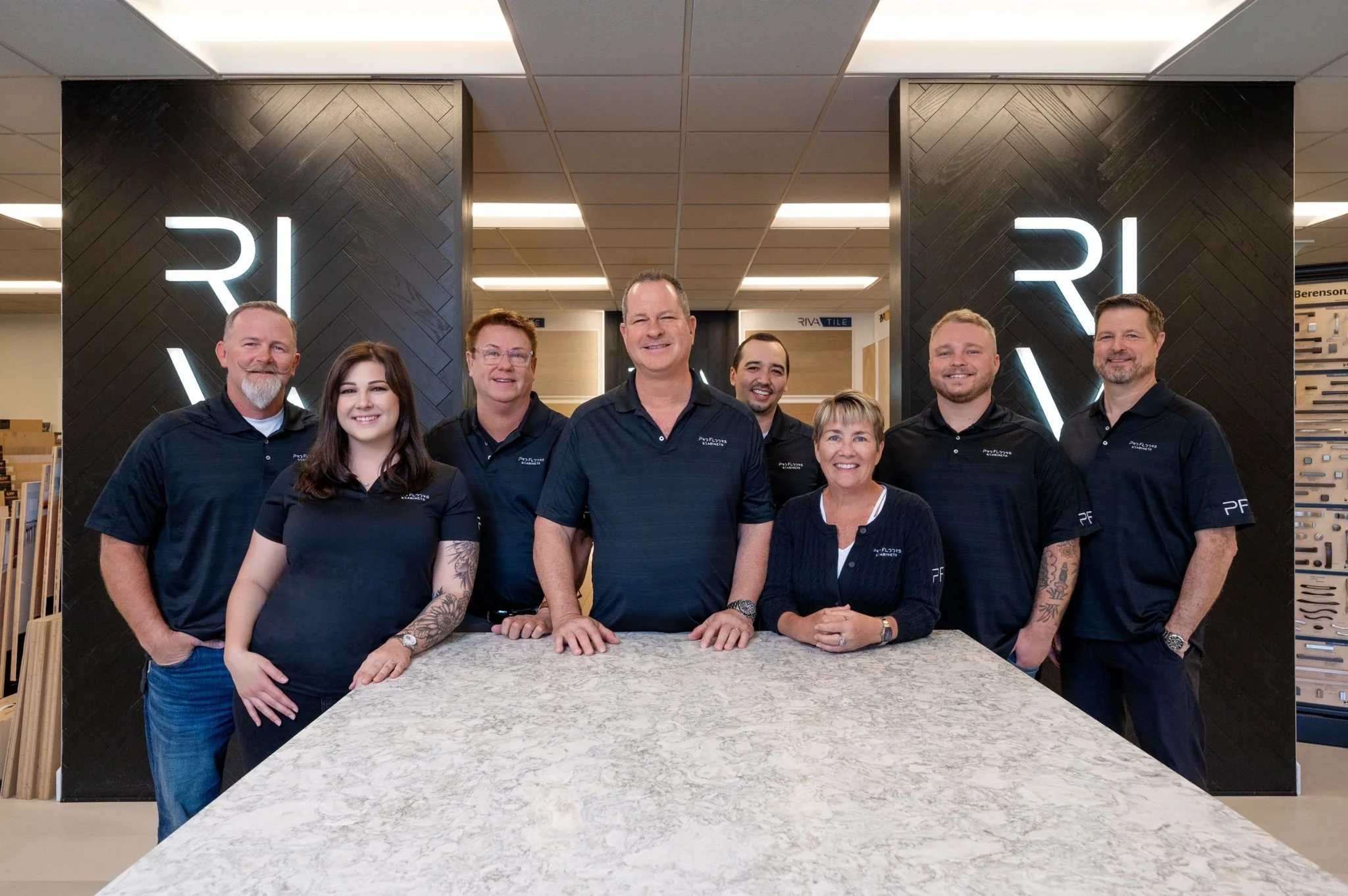 The ProFloorz family team together at the Naples showroom, in front of the RIVA Spain plank wall