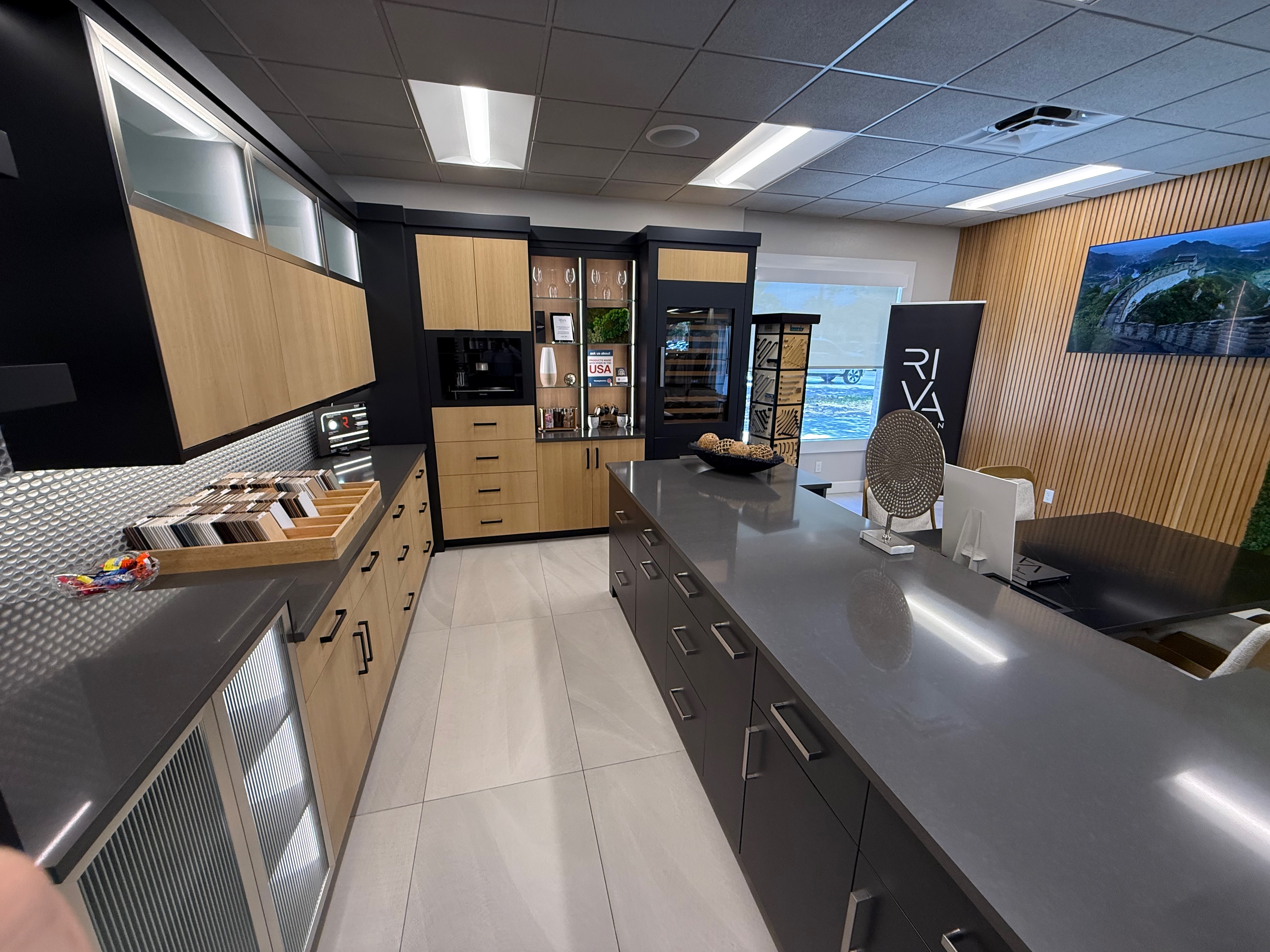 ProFloors showroom — working kitchen vignette with cabinetry and Cambria quartz