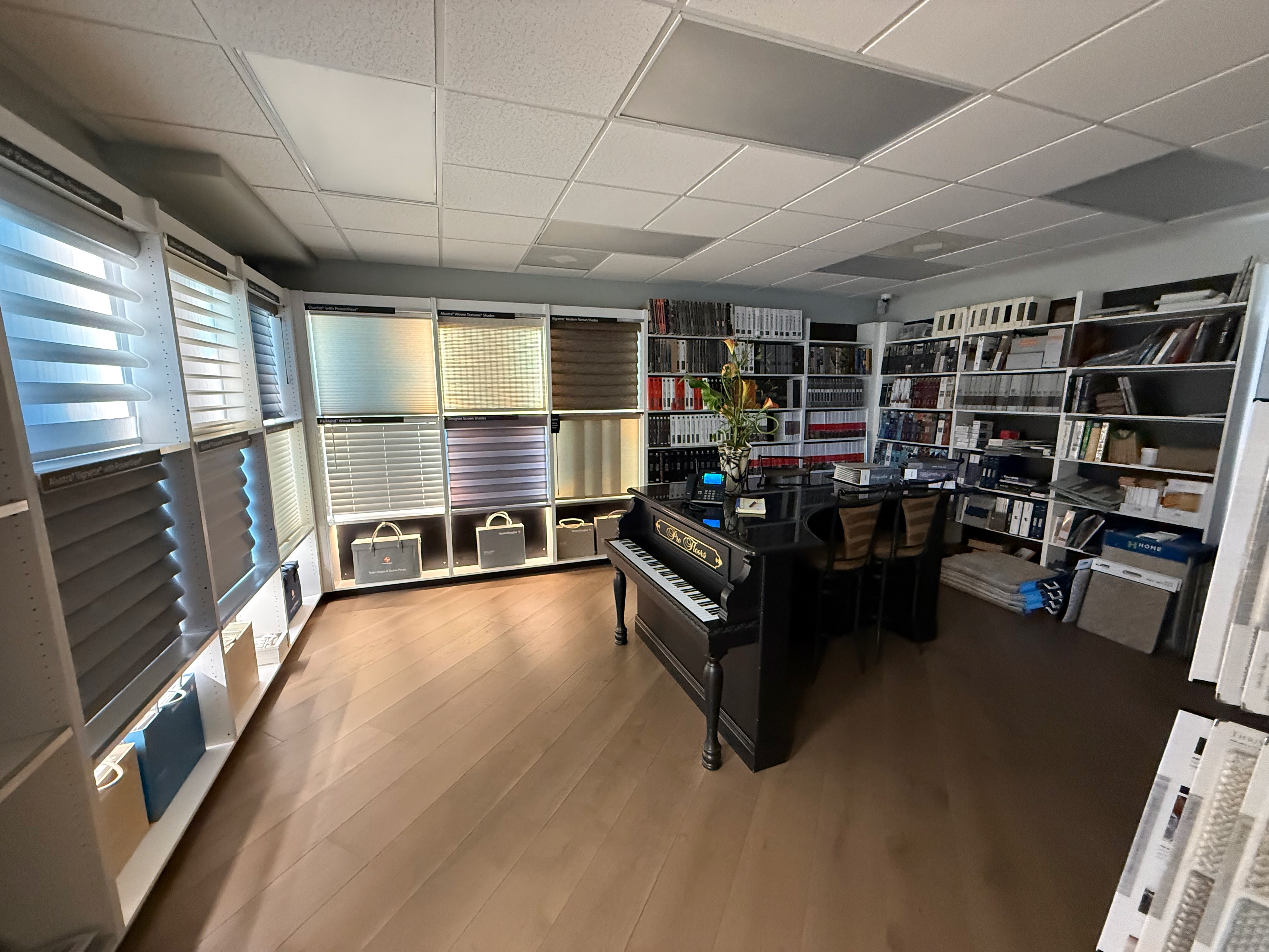 ProFloors Naples showroom wide interior overview — piano room and carpet displays