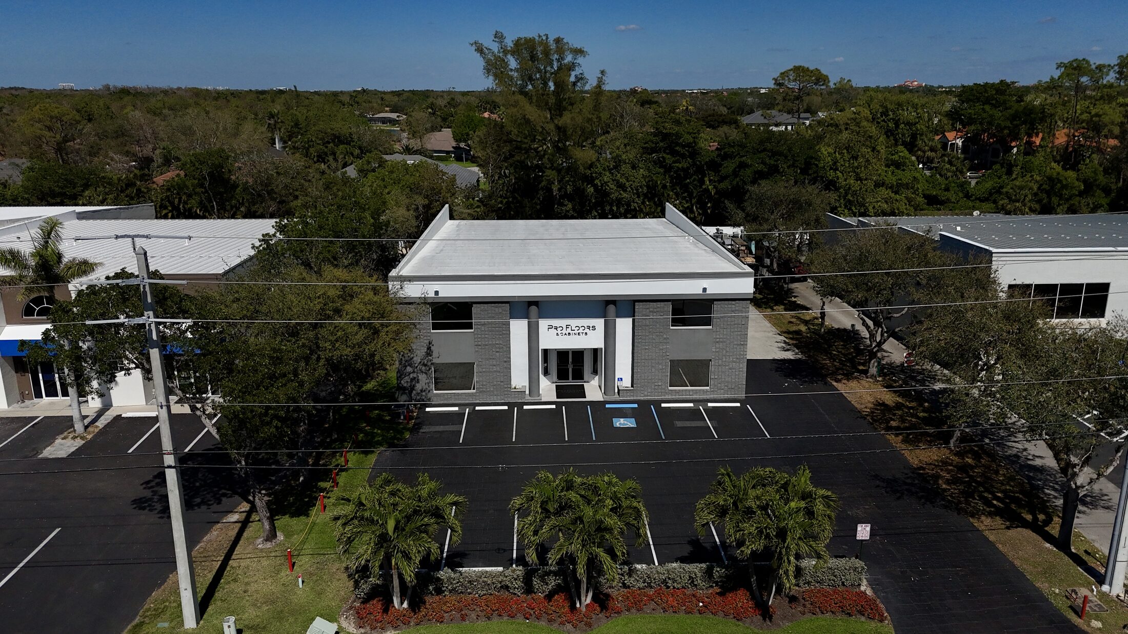 Aerial view of the ProFloors & Cabinets showroom and warehouse at 2033 Trade Center Way, North Naples