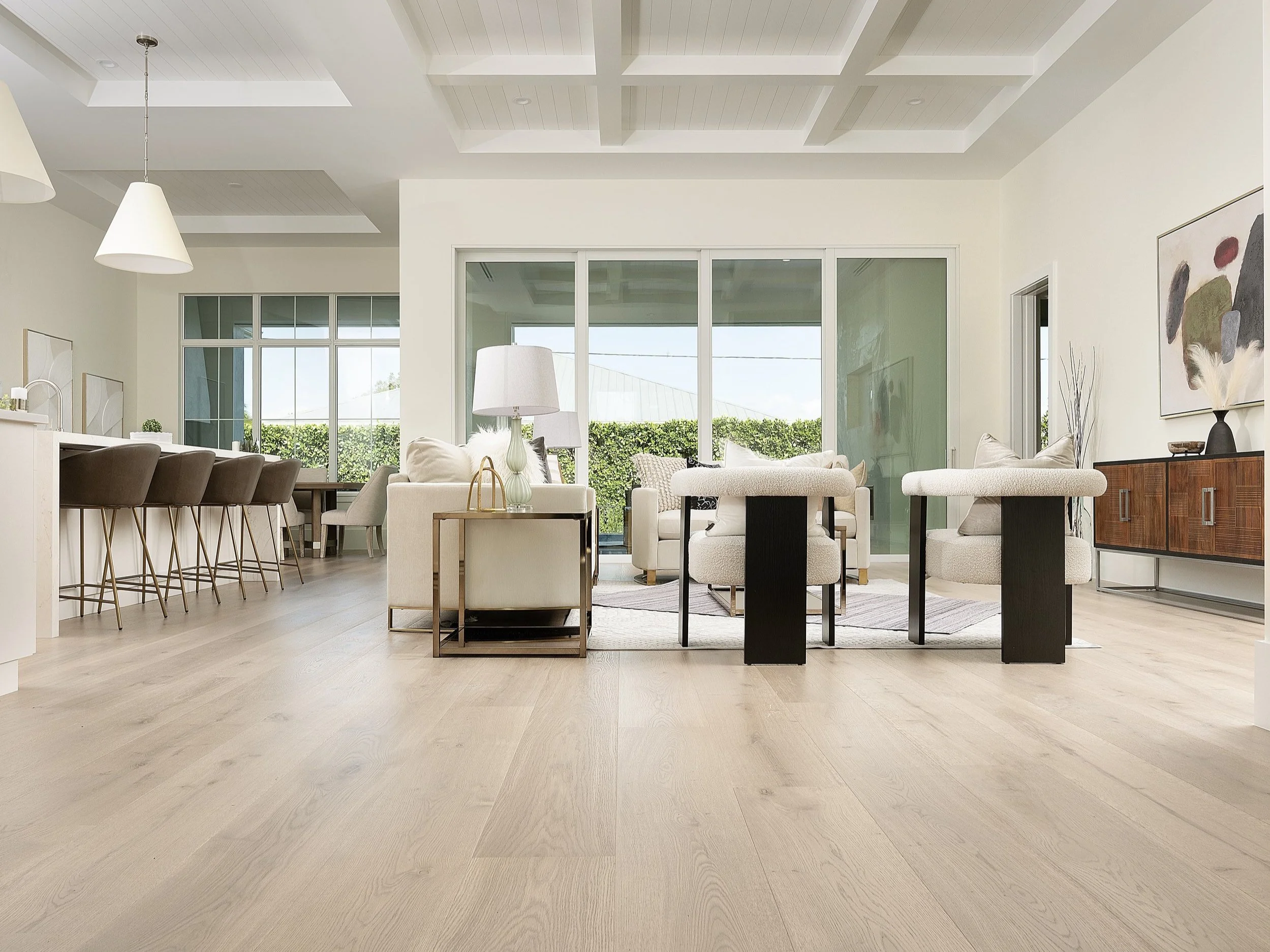 Sunlit Naples great room with coffered ceiling, wide-plank European white oak flowing through the open living and kitchen