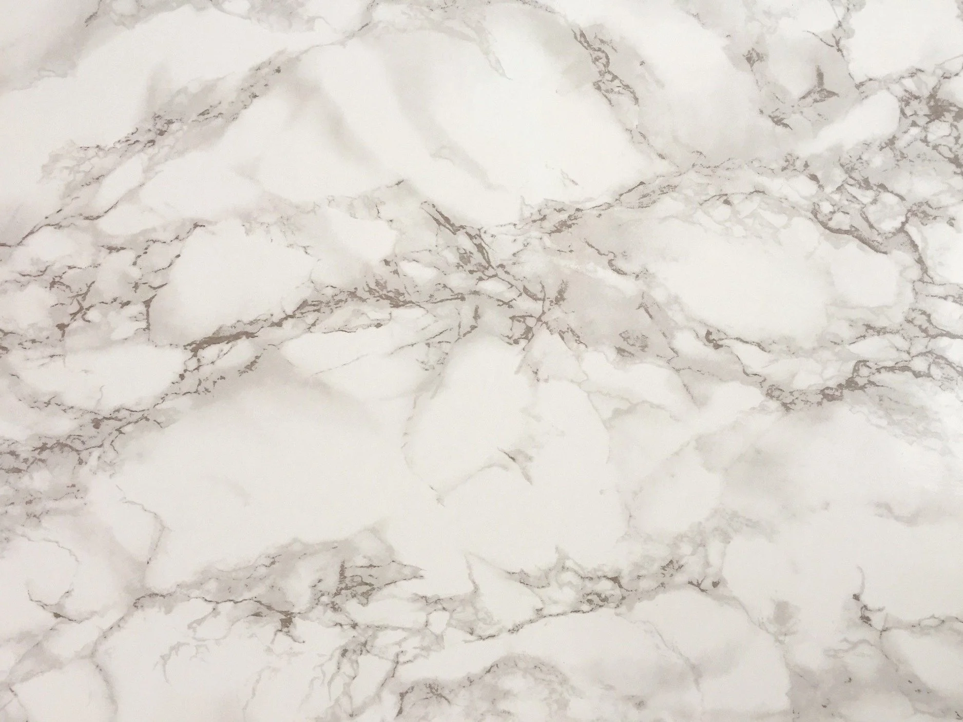 Two adjacent Calacatta marble slabs bookmatched so the grey-silver veining mirrors across the center seam