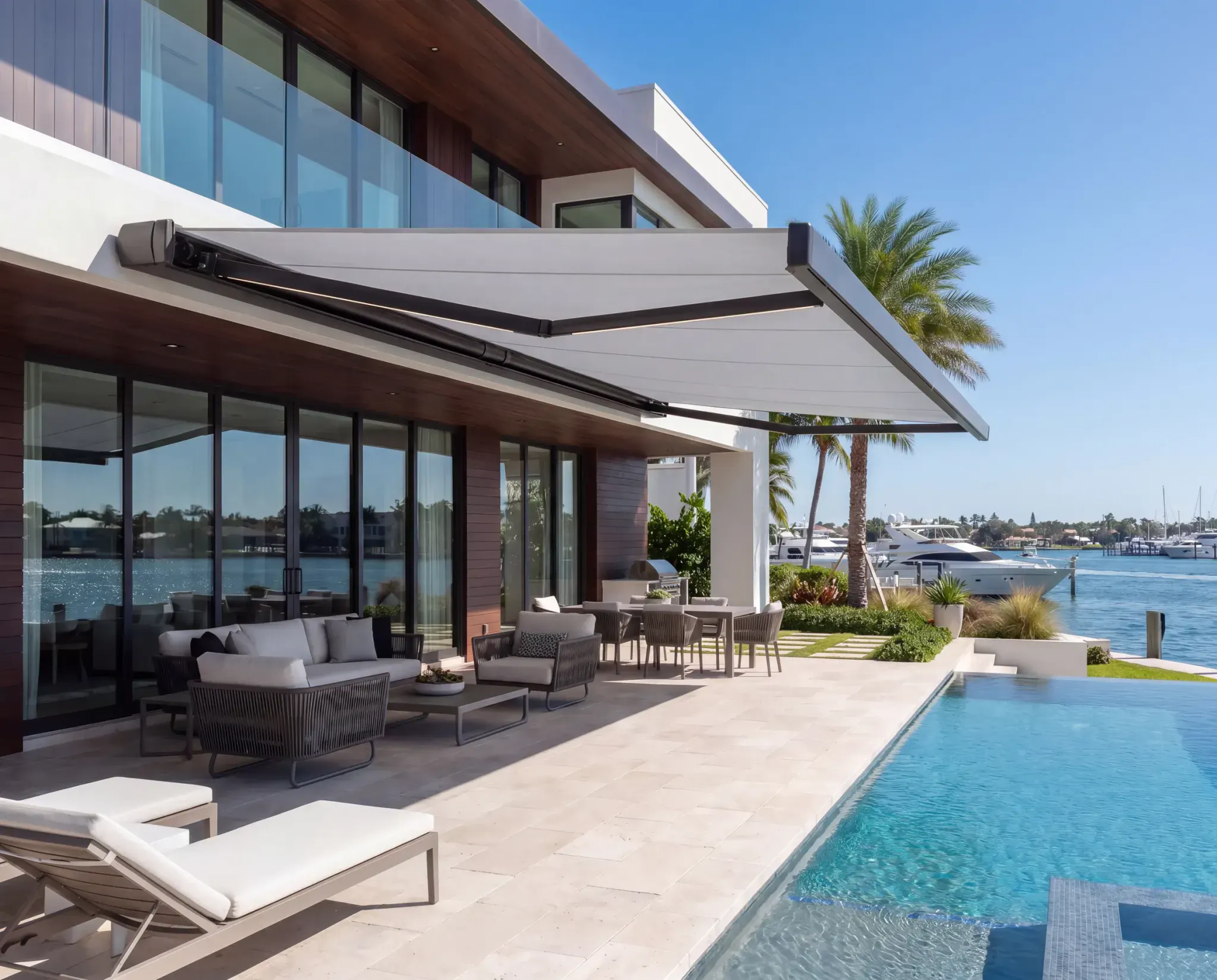 SunPro full-cassette retractable awning shading a waterfront terrace